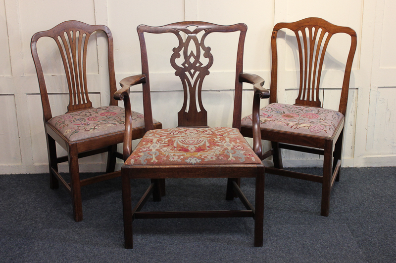 A George III elbow chair and a pair of dining chairs