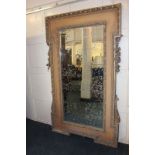 A large carved gilt wood and gesso mirror with egg and dart border and floral swag either side,