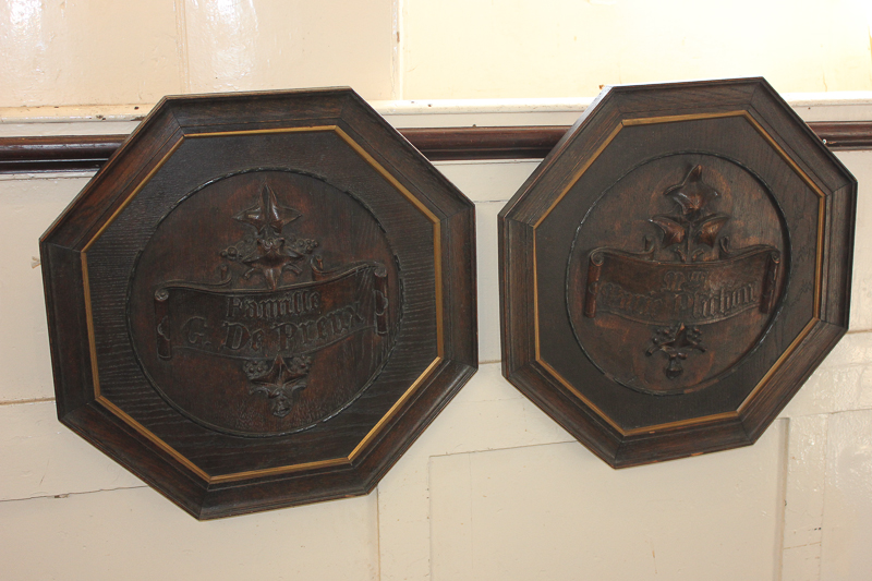 Two French carved wood roundels, famille G de Preux, and M'lle Marie Plinchan, both on a scroll