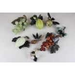 A collection of eight pieces of hardstone fruit including grapes, cherries and a dragon fruit