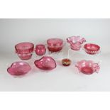 Nine Victorian and later cranberry glass bowls and dishes including a pair of heart shaped dishes