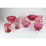 Nine Victorian and later cranberry glass baskets and vases