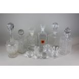 Five various glass decanters, eight stoppers, cut glass thistle shape vase, sugar bowl and a