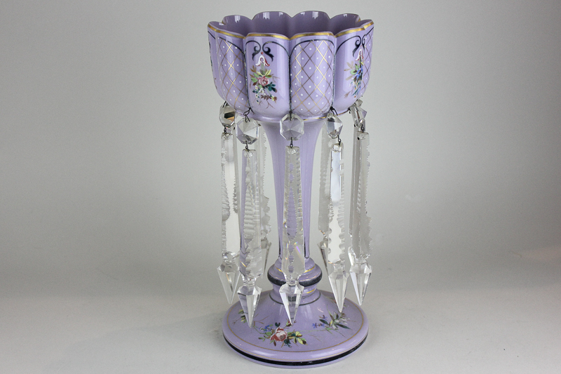 A lilac glass table lustre hung with ten clear glass droplets, 34cm high