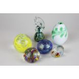 Six glass paperweights including a sea horse and a rabbit, three circular, and one egg shaped
