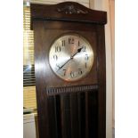 An early 20th century oak longcase clock with Westminster Chimes, the silverised dial with Arabic