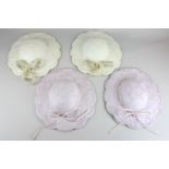 Four French porcelain wall plaques modelled as ladies' hats with ribbons