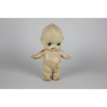 A mid 20th century Kewpie character plastic doll without clothes, some discolouration, 23cm