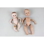 Two plastic dolls with unassembled limbs, 14cm