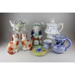 A pair of Staffordshire dogs, a Continental heavily bocaged teapot, a Toby jug, a Victorian