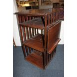 An early 20th century oak revolving bookcase with slatted sides and lift-out writing slope, formerly