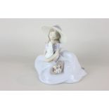 A Lladro porcelain figure of a seated girl with a rabbit, the 2001 event figurine (6741), 19cm