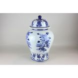 A large 20th century Chinese blue and white ginger jar and cover decorated with floral designs, 35cm