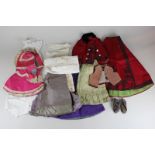 A collection of Edwardian and later period doll's clothing including skirts and jackets