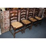 A set of four oak ladder back rush seat chairs