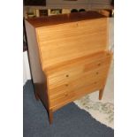 A light oak bureau, mid 20th century with drop down flap over pigeon holes above two short and two
