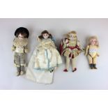 Three bisque head dolls circa 1900 dressed as a lord, a lady and a cavalier, with glass eyes and