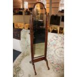 A walnut framed adjustable cheval mirror with shaped dome glass on twin supports and castors,