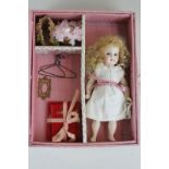 A china doll with accessories, nicely boxed and presented