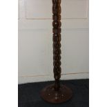 An African hardwood standard lamp with carved twist detail, 166cm