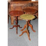 Two mahogany circular wine tables and another wine table with green tooled leather top, on tripod