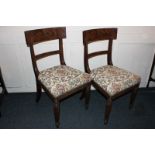 A pair of 19th century mahogany dining chairs with curved back supports, tapestry seats on reeded