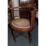 A Victorian tub chair with slatted back and oval tapestry seat