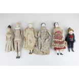 Six 19th century porcelain pumpkin head dolls with blond and black hair and painted features, five