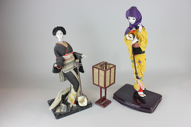 Two Japanese composite dolls on stands in traditional dress, together with a lantern