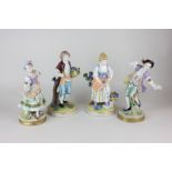 A pair of Dresden porcelain figures of a lady and gentleman picking flowers, together with a pair of