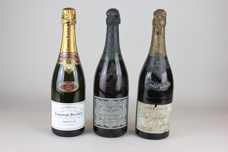 A bottle of 1919 Leon Gobert Champagne, a bottle of Moet & Chandon Champagne, and a Laurent