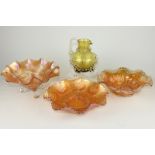 Three carnival glass scalloped dishes and a yellow glass jug with scroll swag decoration