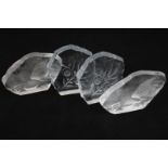 Two pairs of intaglio glass paperweights decorated with flowers and fish