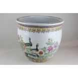 A Chinese porcelain jardiniere decorated with peacocks in a garden (a/f - repaired), 30cm diameter