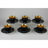 A set of six Noritake coffee cups and saucers in black glaze with gilt interior