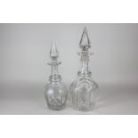 Two Victorian Gothic revival cut glass decanters with faceted bodies and spire stoppers, tallest
