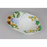 A Clarice Cliff porcelain dish modelled as a bridge over a stream surrounded by flowers and