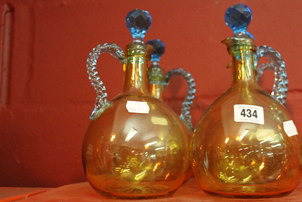 19th cent. French glass: Portieux brown decanters, blue rope handles and stoppers. (4).