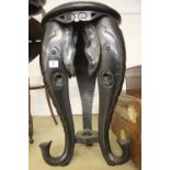 20th cent. Ebonised African occasional table with elephant head supports.
