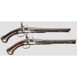 A pair of French flintlock pistols, circa 1700   Above the breech faceted barrels merging to round