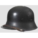 A lightweight steel helmet M 16 95 % black paint, one ventilation hole on each side, dark brown