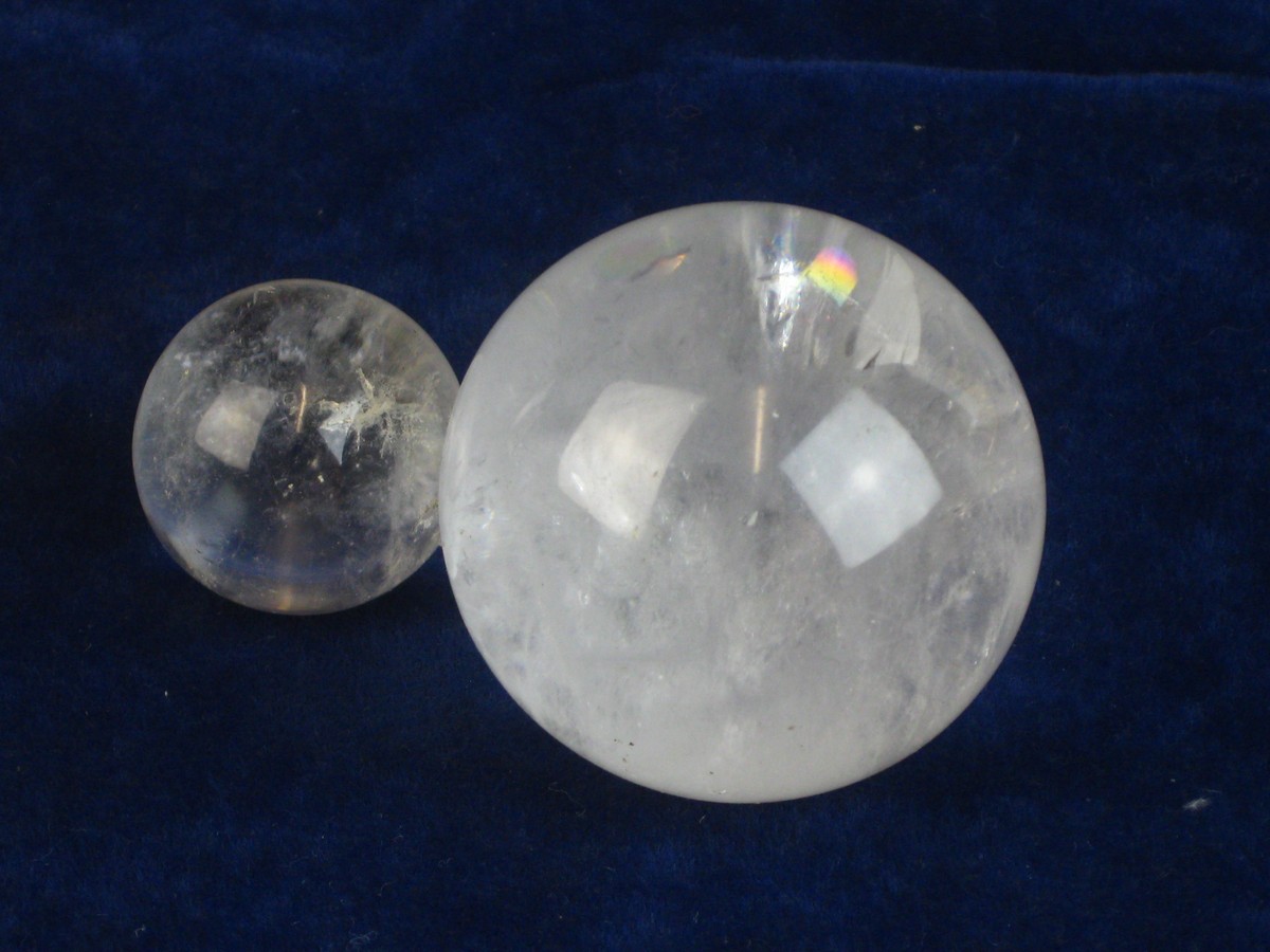 POLISHED QUARTZ SPHERES.  A pair of polished quartz spheres; the larger with a diameter of @ 2 ¼