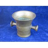 C17th BRONZE MORTAR.   A small size cast bronze mortar with two integral handles, 3 ½ inches tall