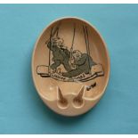 An amusing oval pottery ashtray printed in black with a cartoon after David Low entitled 'Empire