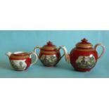 A teapot, sucrier and milk jug each well decorated with brick red ground, gold line decoration and