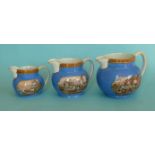 A graduated set of three squat jugs with blue ground, gold line decoration and 123 borders,