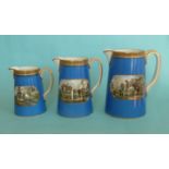 A graduated set of three tapering jugs with blue ground, gold line decoration and 123 borders,