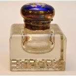 A SILVER MOUNTED INKWELL WITH ENAMEL TOP