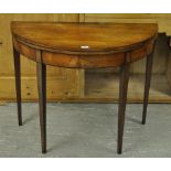 A GEORGE III MAHOGANY DEMI-LUNE TEA TABL