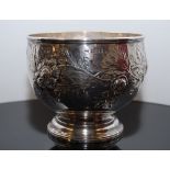 A SILVER FOOTED BOWL EMBOSSED WITH FLOWE